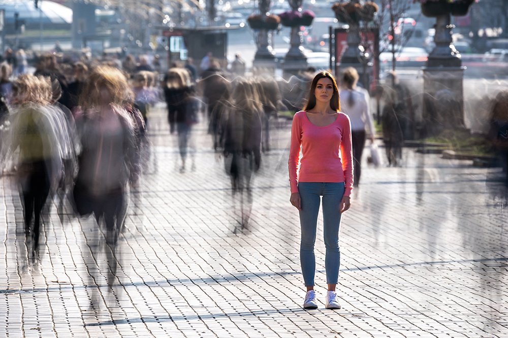 woman feeling alone in a crowded street