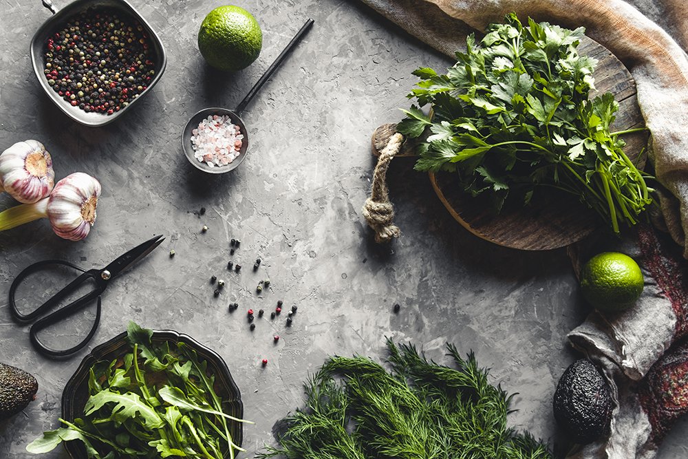Bunch of fresh homegrown organic dill, spinach, arugula and spring onion on rustic wooden table