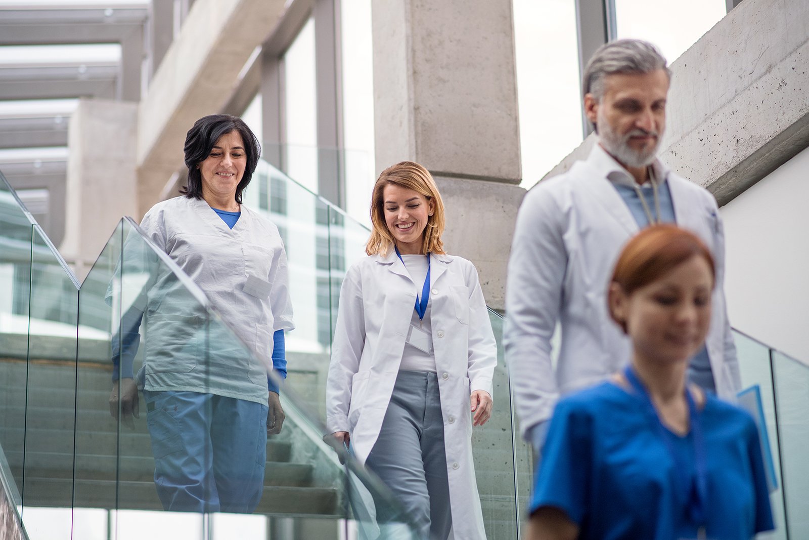 group of doctors walking down stairs in hospital