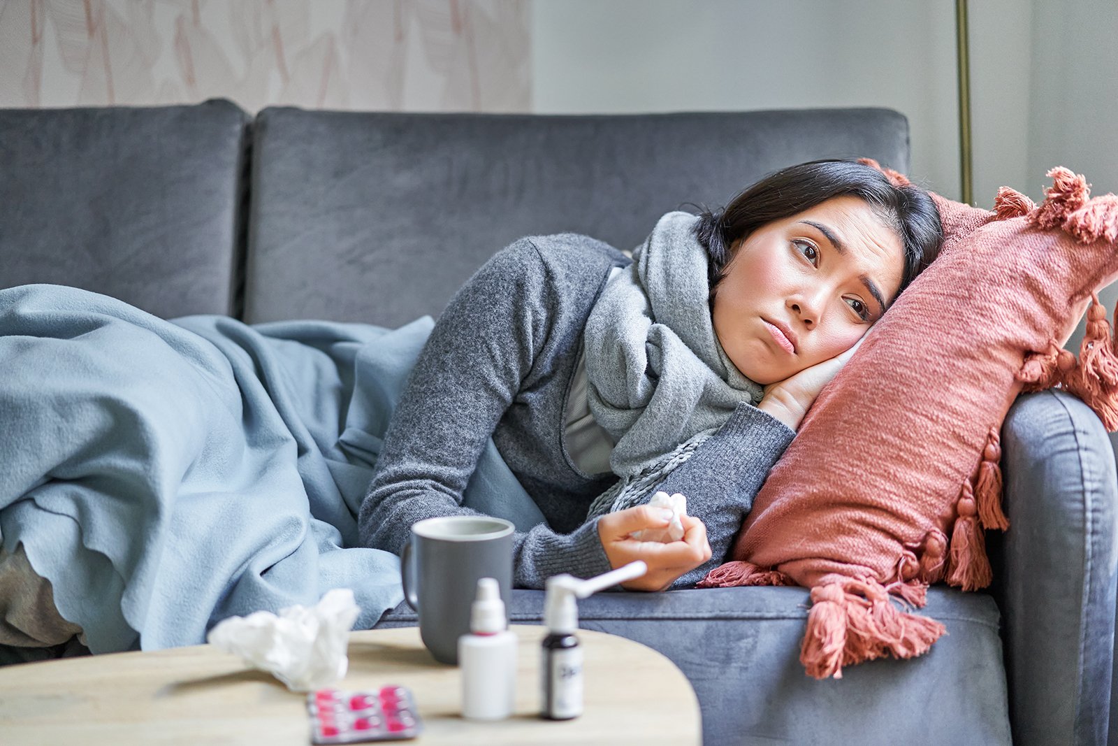 sick woman with chronic illness lying on couch