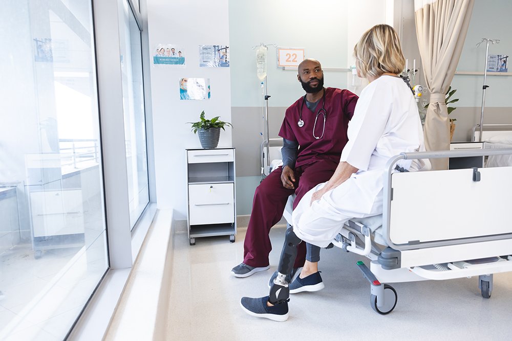 doctor talking with patient in a hospital room